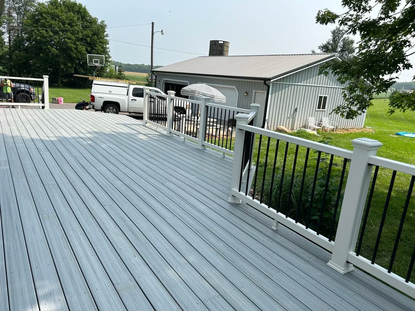 Gray composite deck with white posts and black aluminum balusters