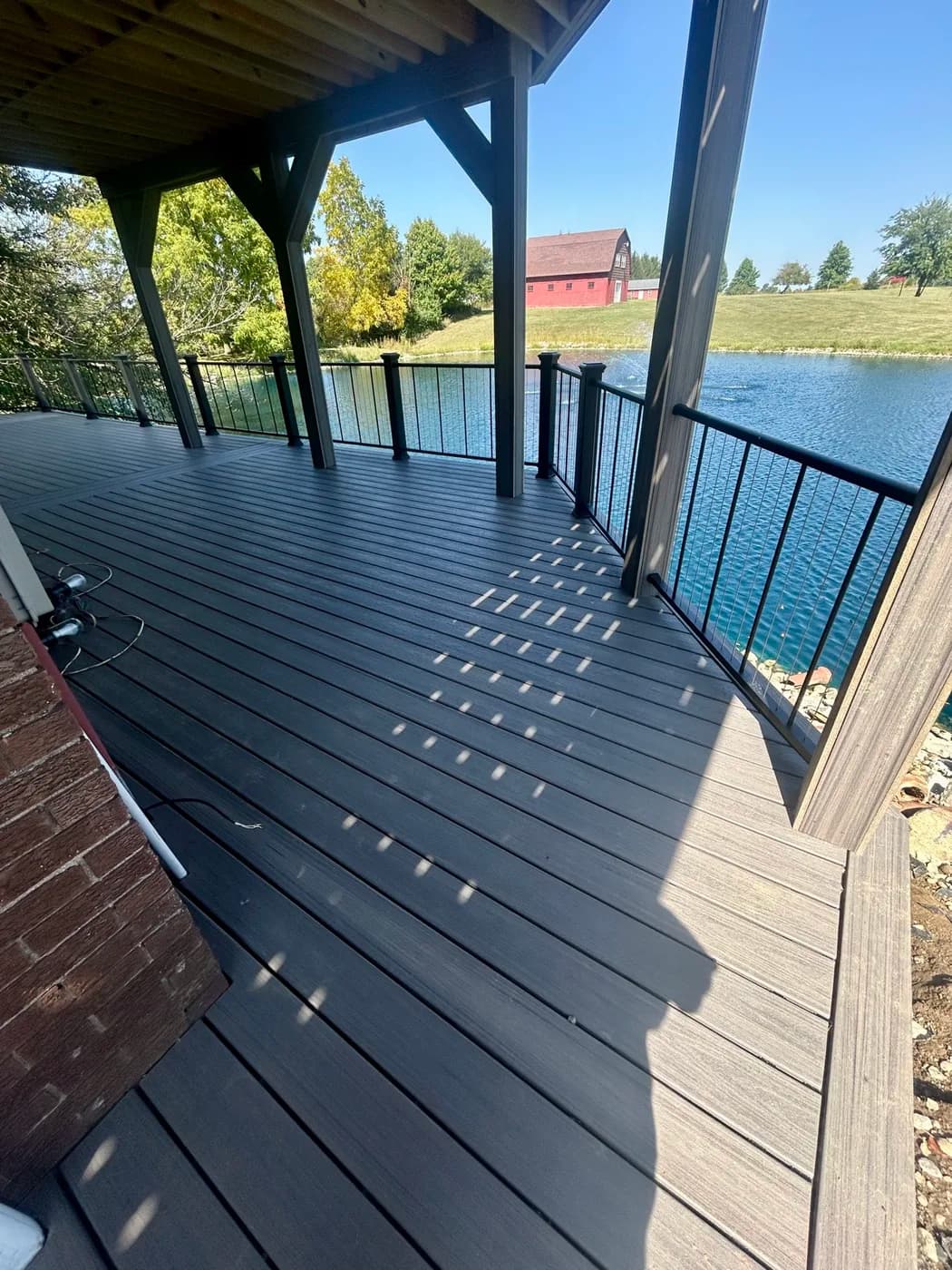Covered composite deck overlooking a private lake in Indiana