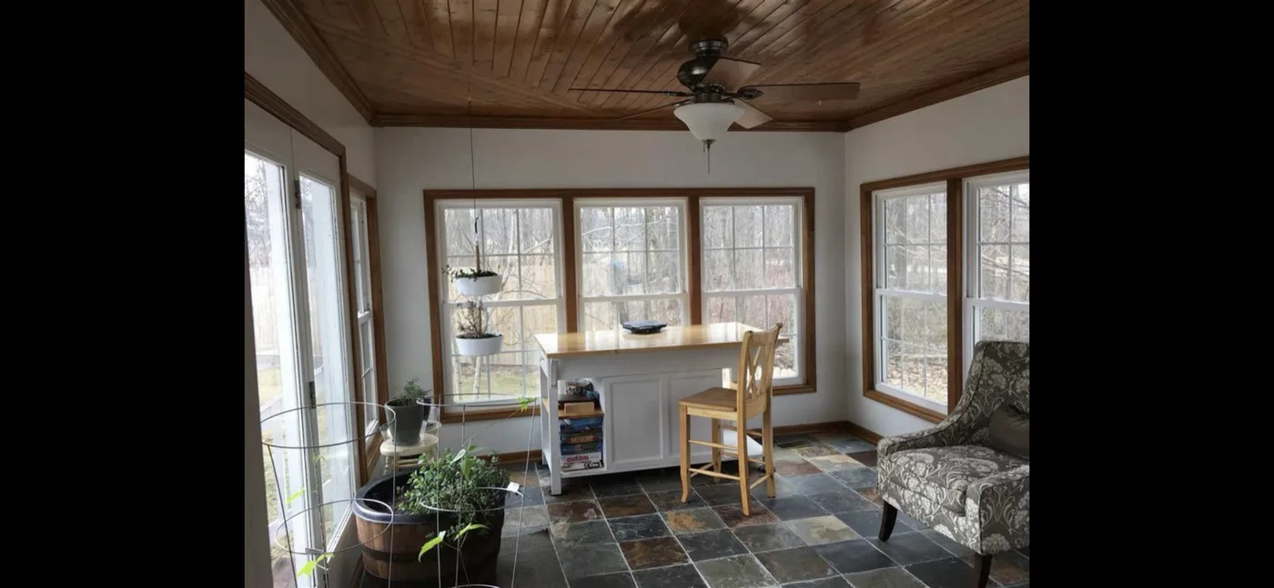 Finished sunroom with tongue-and-groove ceiling and slate tile floor